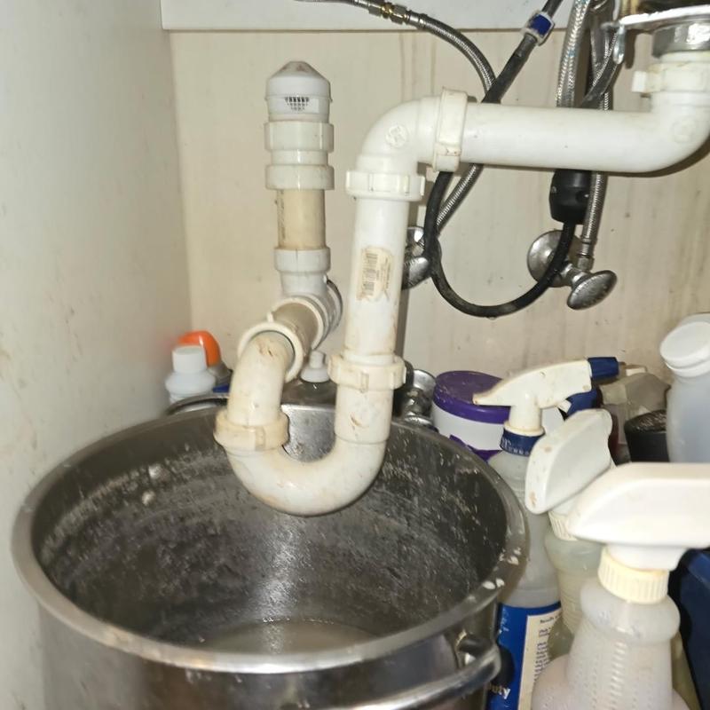 Kitchen sink P-trap and drain pipe cleaning with snake