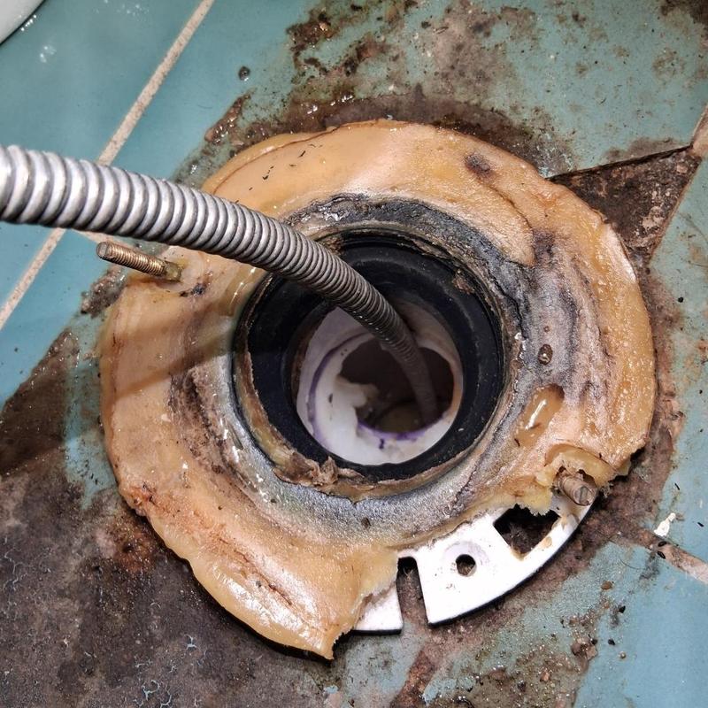 Main drain with plumbing snake clearing blockage