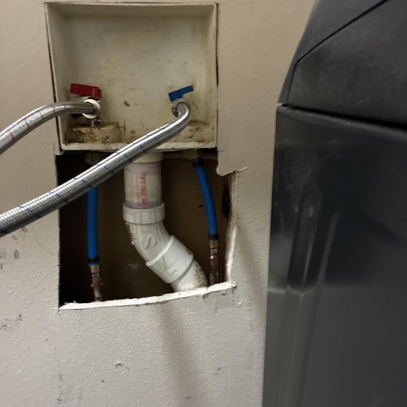 Washing machine water valves and drain pipes exposed