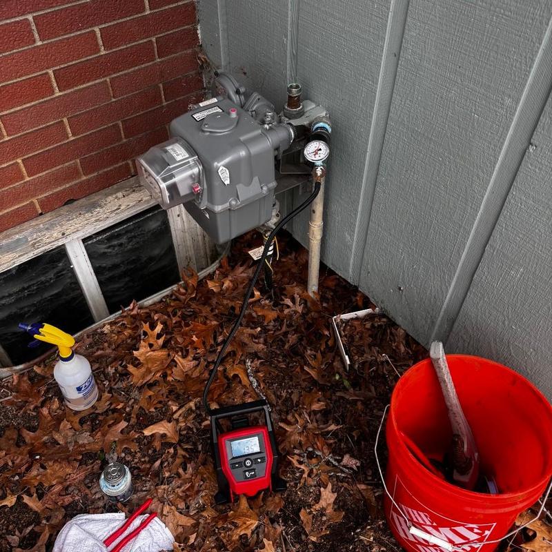 Gas meter with pressure gauge and testing device outdoors