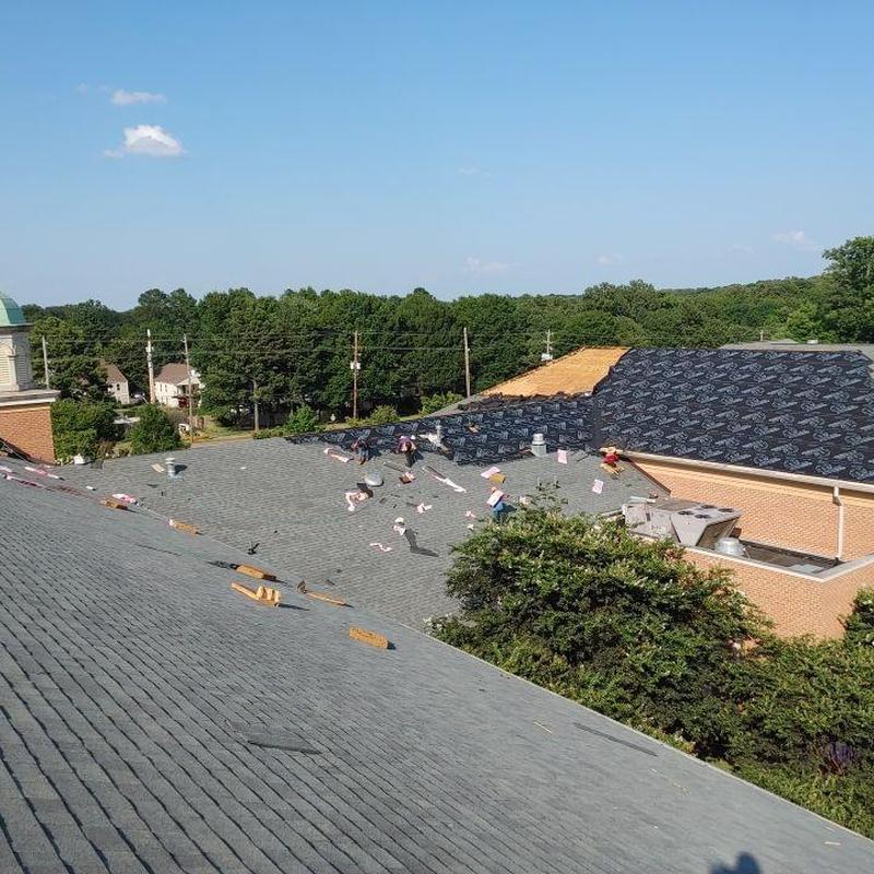 Asphalt shingle roof installation on commercial building