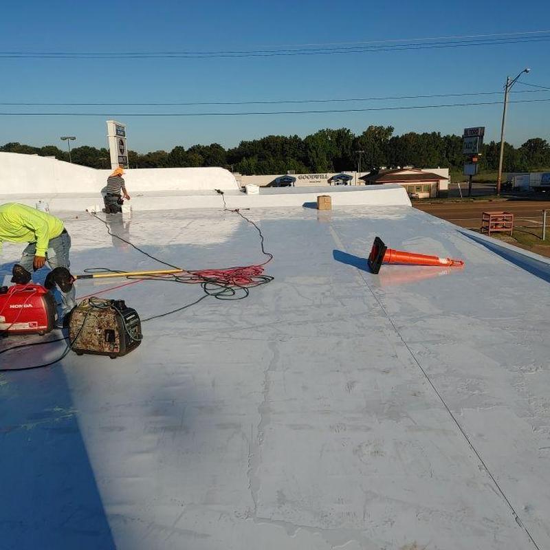 Single ply TPO roof installation with workers and equipment