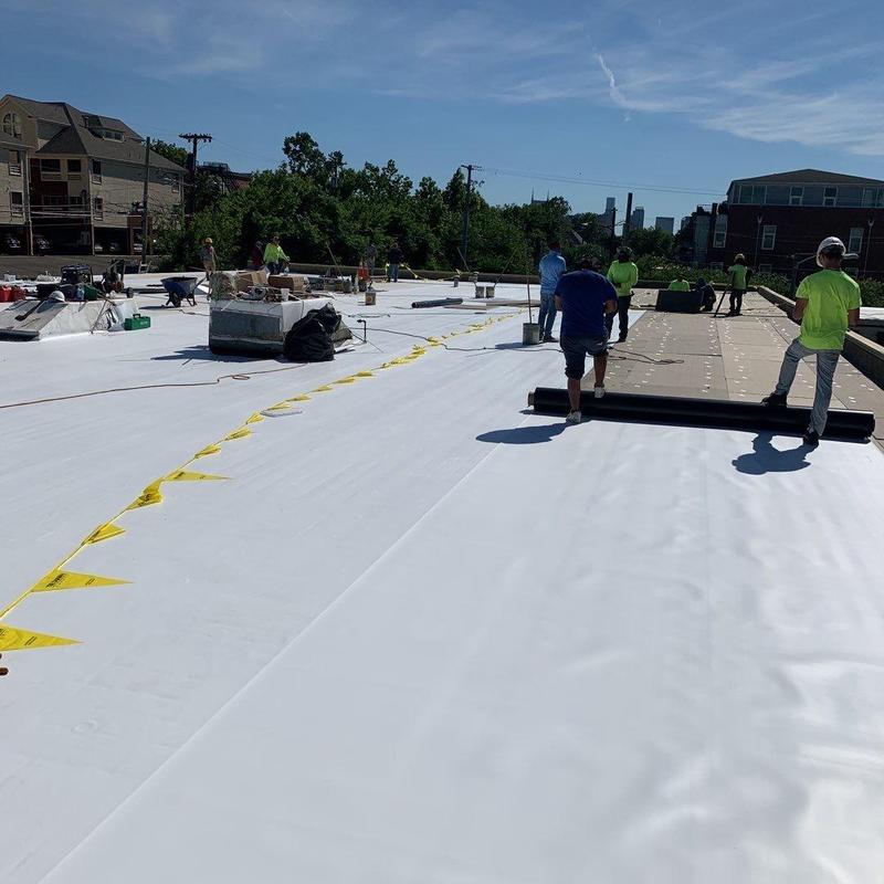 Single ply TPO roof installation on commercial building