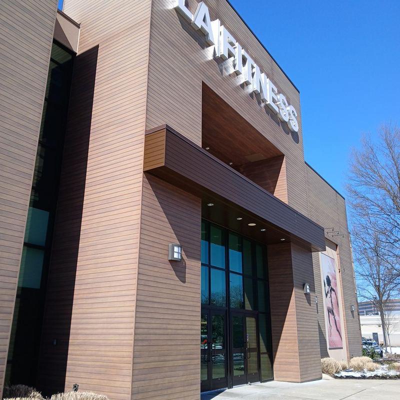 Single ply roof installation on gym building exterior