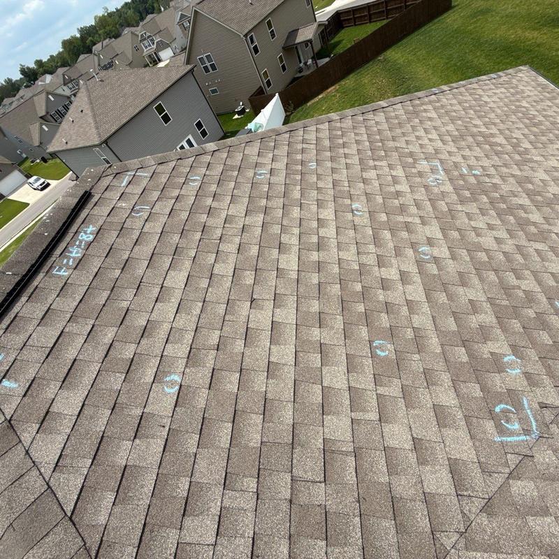 Asphalt shingle roof with hail damage markings
