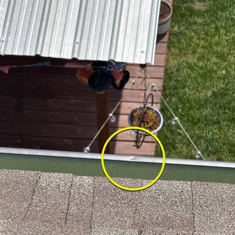 Metal roof edge dent from hail impact