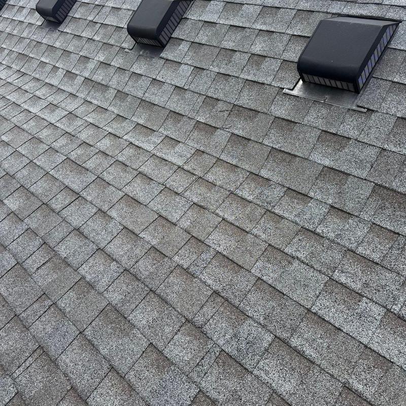 Asphalt roof shingles with hail damage and vents