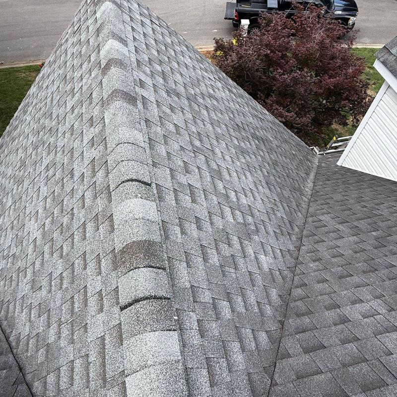 Roof shingles with hail damage and edge lifting