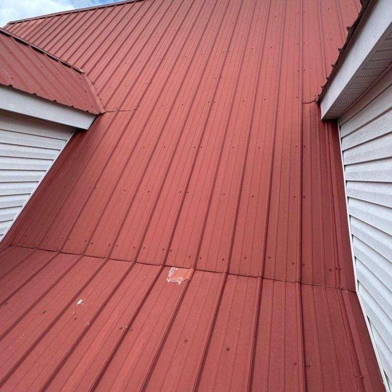 Metal roofing panel with hail damage spots