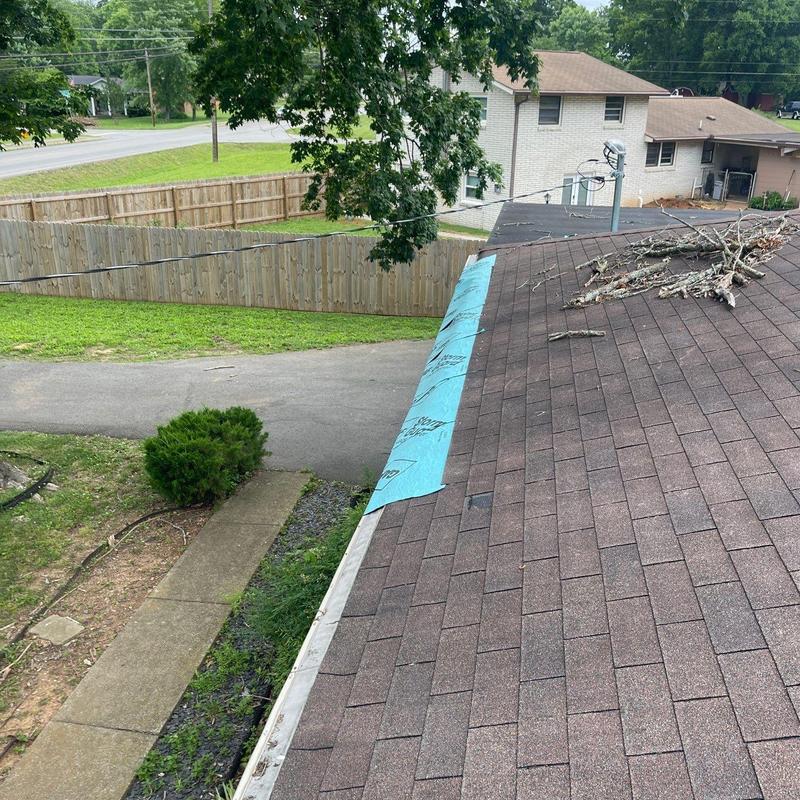 Roof shingles with underlayment repair near gutter