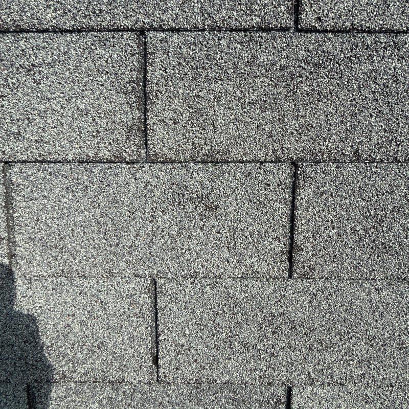 Asphalt shingles with hail damage and wear