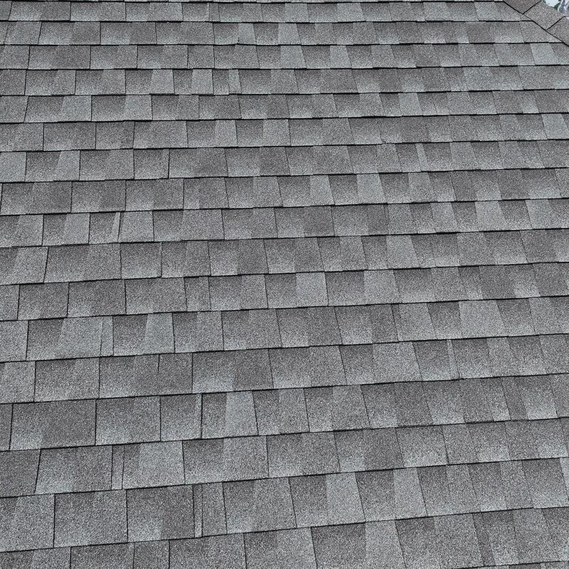 Asphalt shingle roof with hail and wind damage