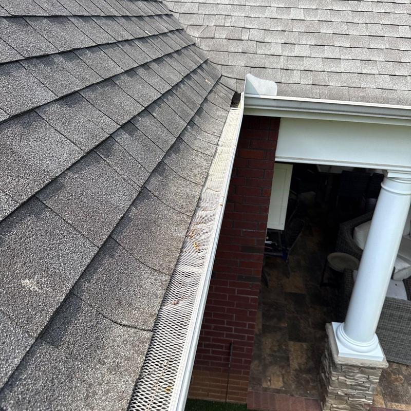 Asphalt shingle roof and gutter with leaf guard installed