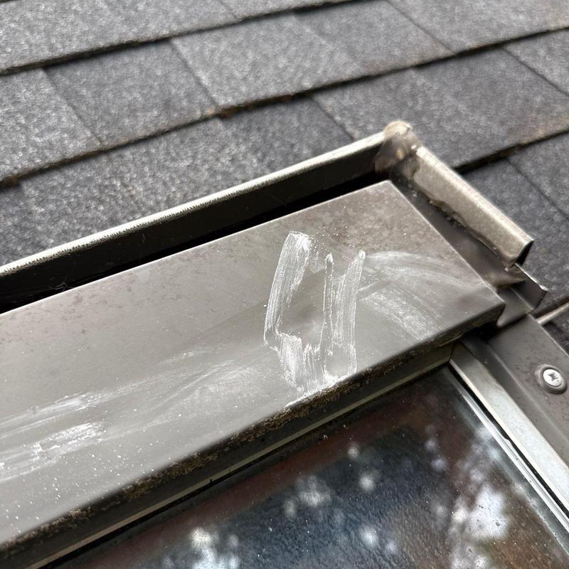 Metal flashing with scratches on roof shingles