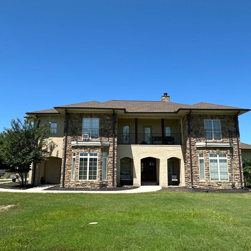 Asphalt shingle roof on two-story stone home