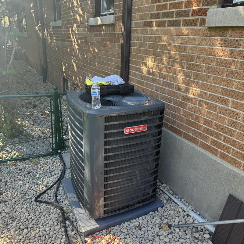 Goodman AC condenser unit on outdoor pad