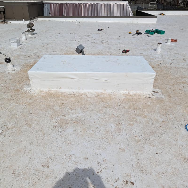 PVC single ply roofing covering old AC unit base on roof