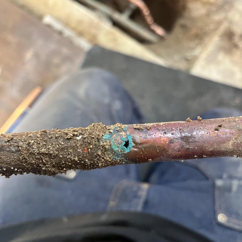 Copper water pipe with corrosion hole in kitchen slab leak