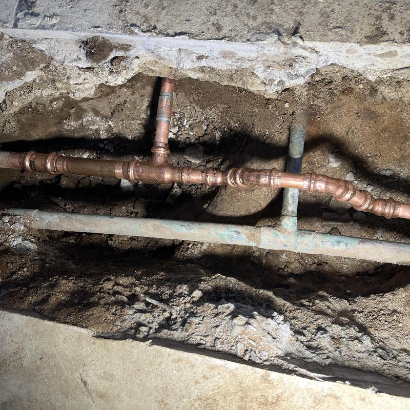 Copper hot water supply pipe in slab leak repair