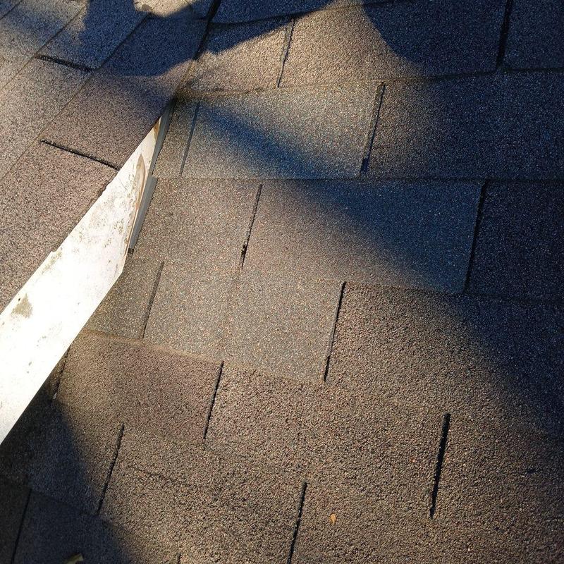 Step flashing and asphalt shingles on roof edge