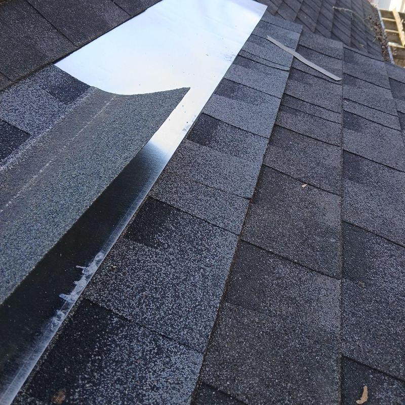 Chimney flashing installation on asphalt shingle roof