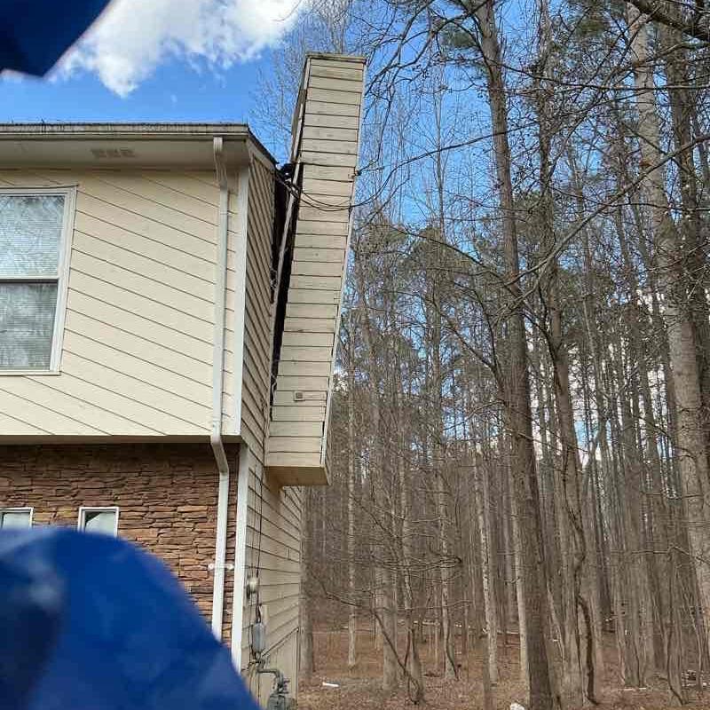 Chimney reframing and siding replacement on house exterior