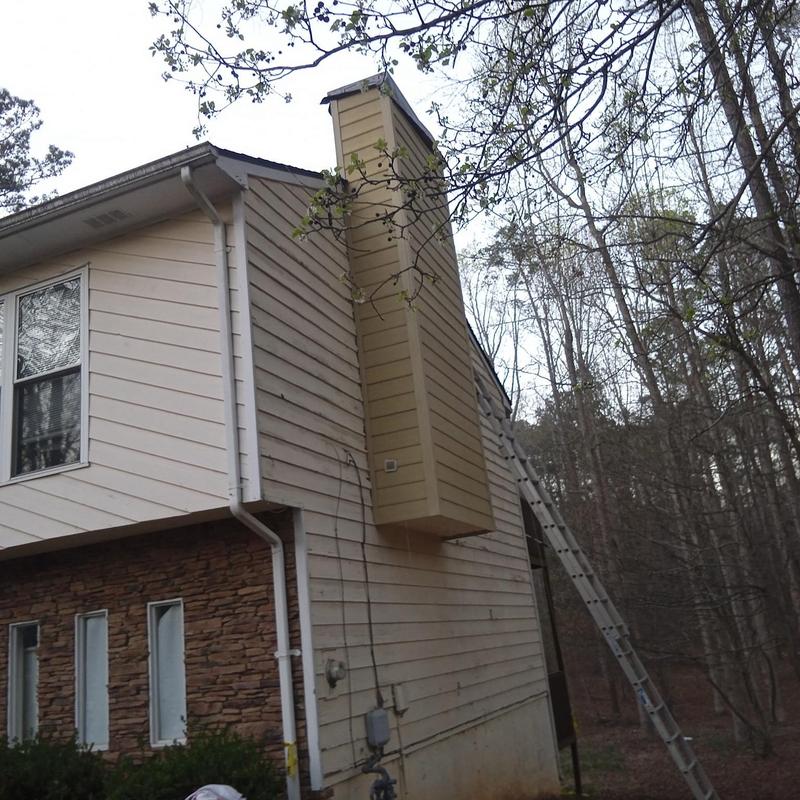 Chimney reframing and siding replacement on house exterior