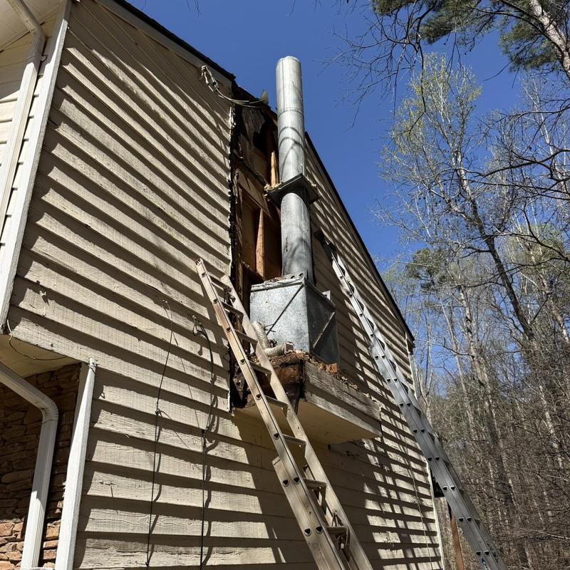 Chimney reframing and siding removal on house exterior