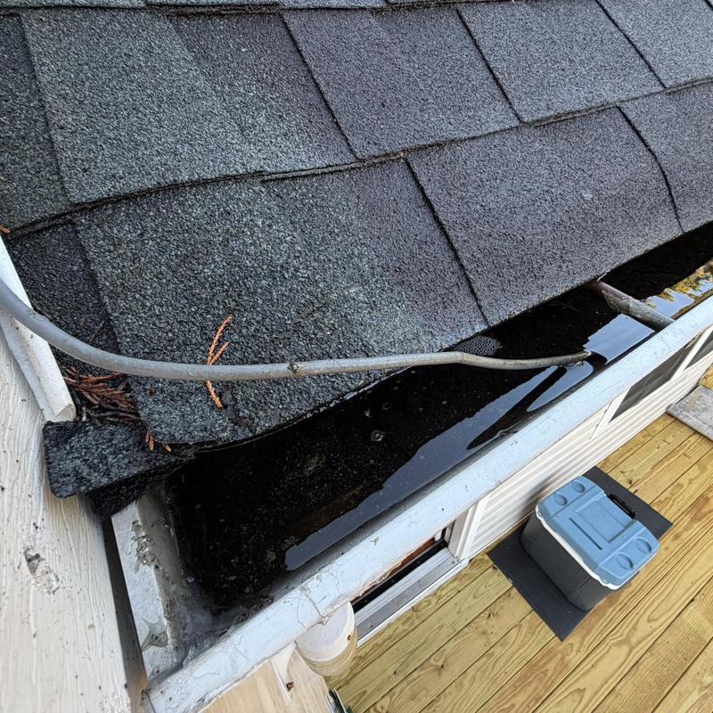White 5-inch gutters with debris and standing water