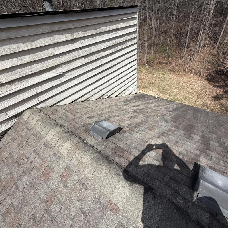 Roof shingles and chimney flashing on residential roof