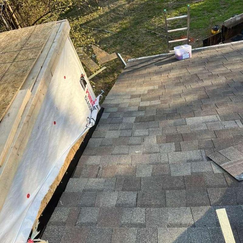 Asphalt roof shingles replacement near chimney flashing