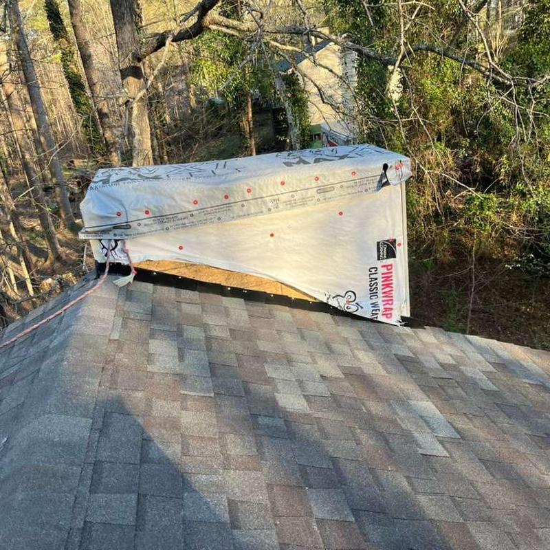 Chimney wrap and roof shingle replacement in progress