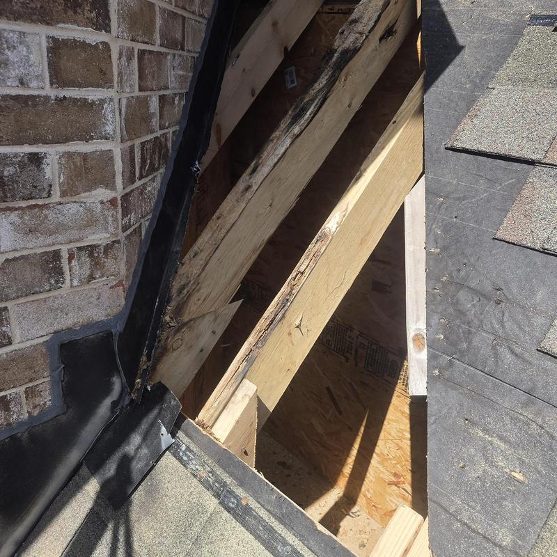 Roof decking replacement and wall flashing near brick wall