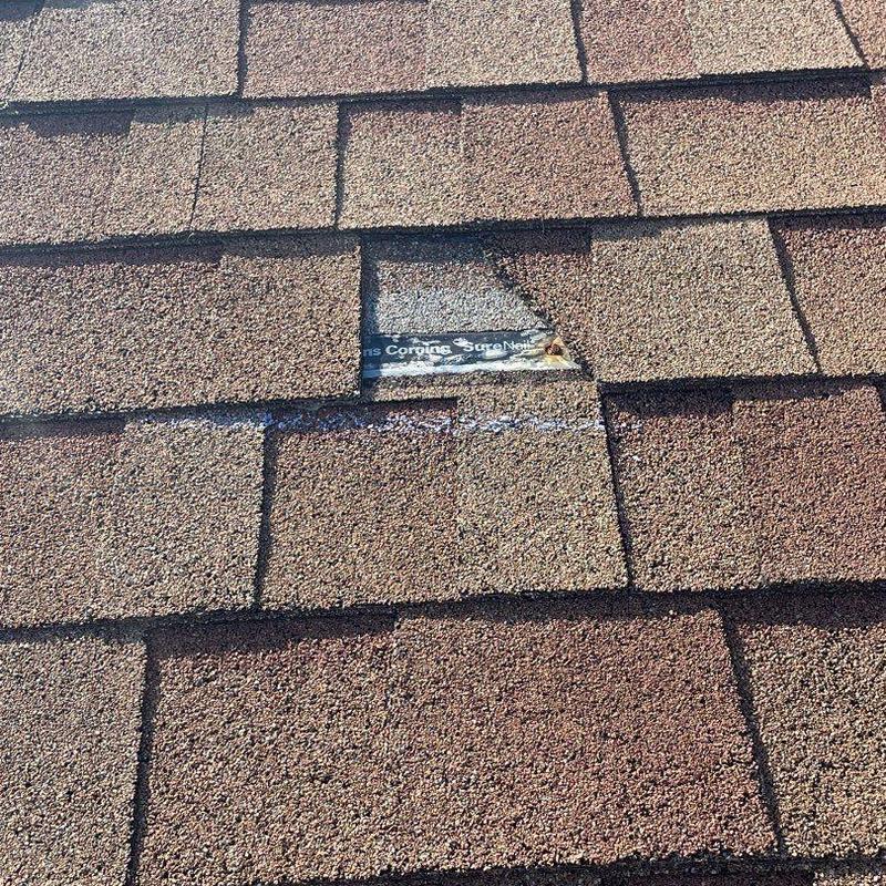 Owens Corning shingle with damaged spot on roof