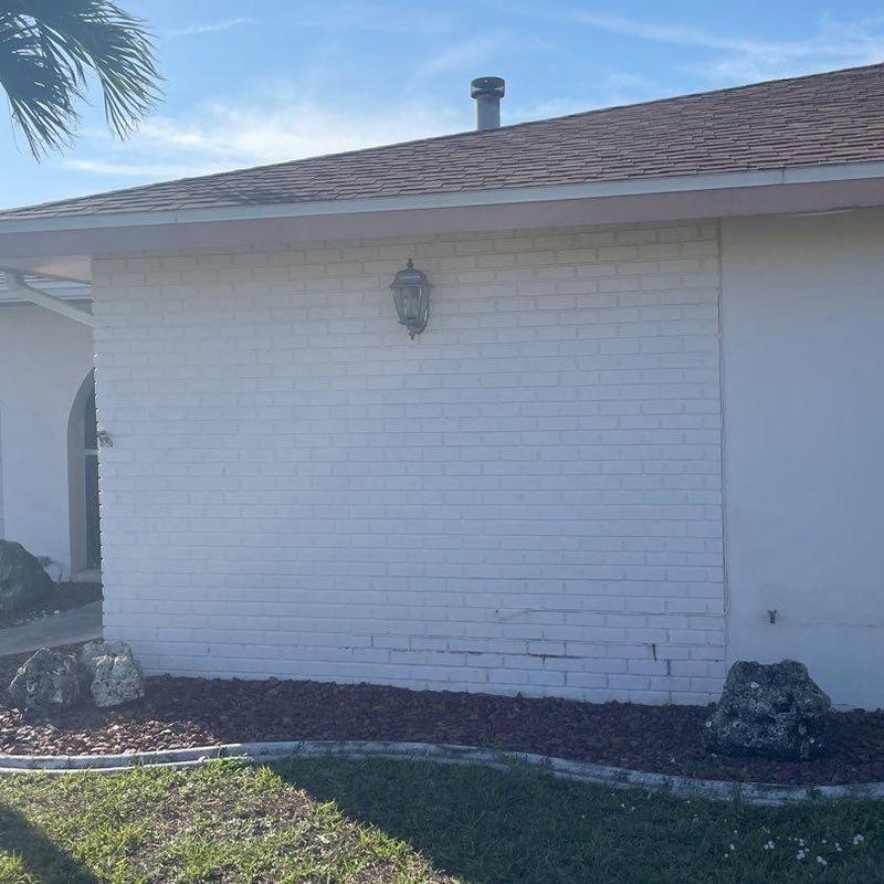 Brick veneer exterior wall with minor cracks in Cape Coral