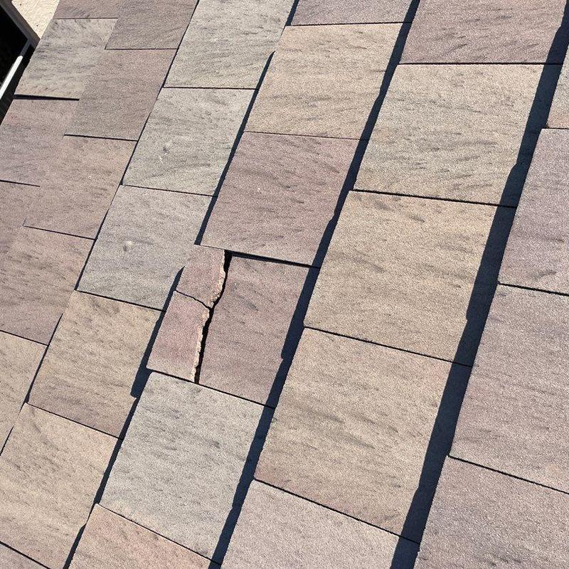 Concrete tile roof with cracked and damaged tiles