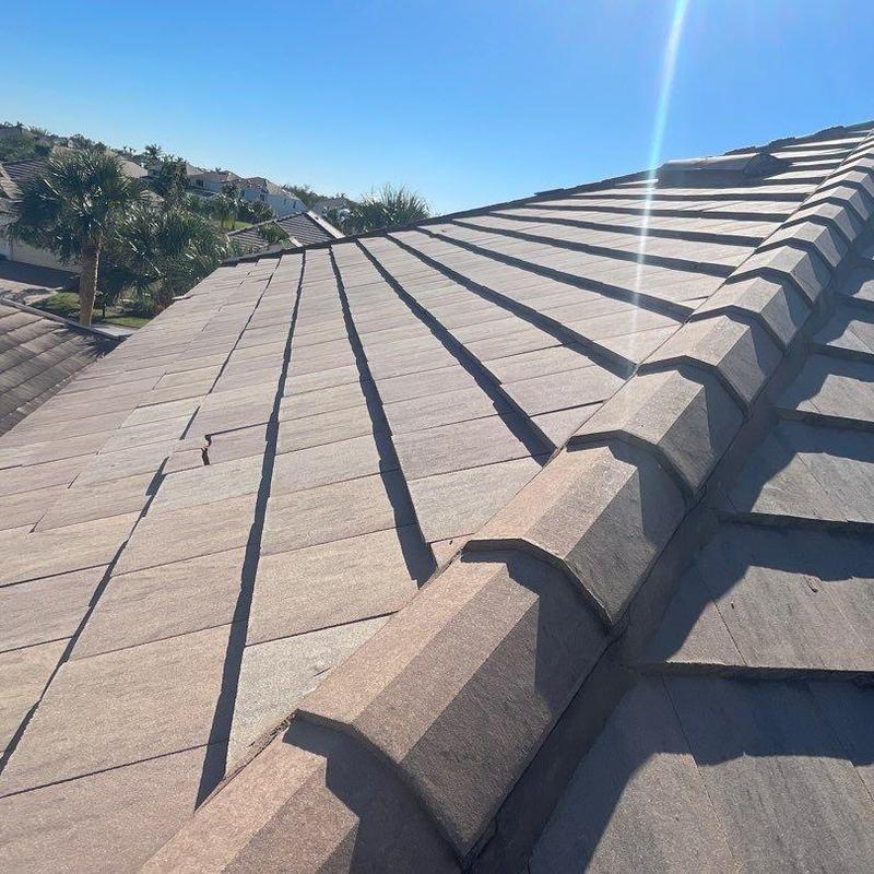 Concrete tile roof with cracked and damaged tiles