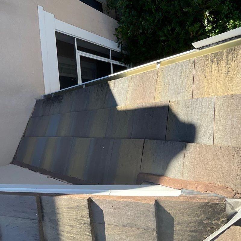 Concrete tile roof with cracked and slipping tiles