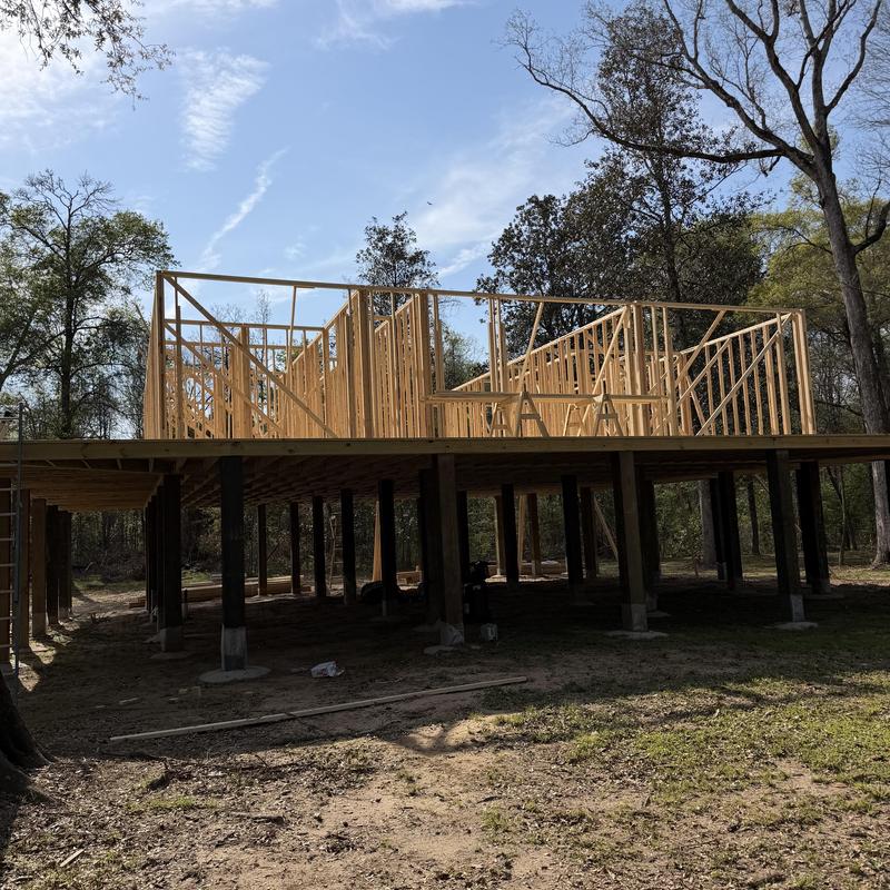 Wood frame wall construction on raised foundation