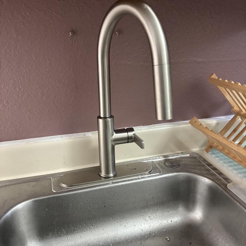 Kitchen faucet with high-arc spout installed over sink