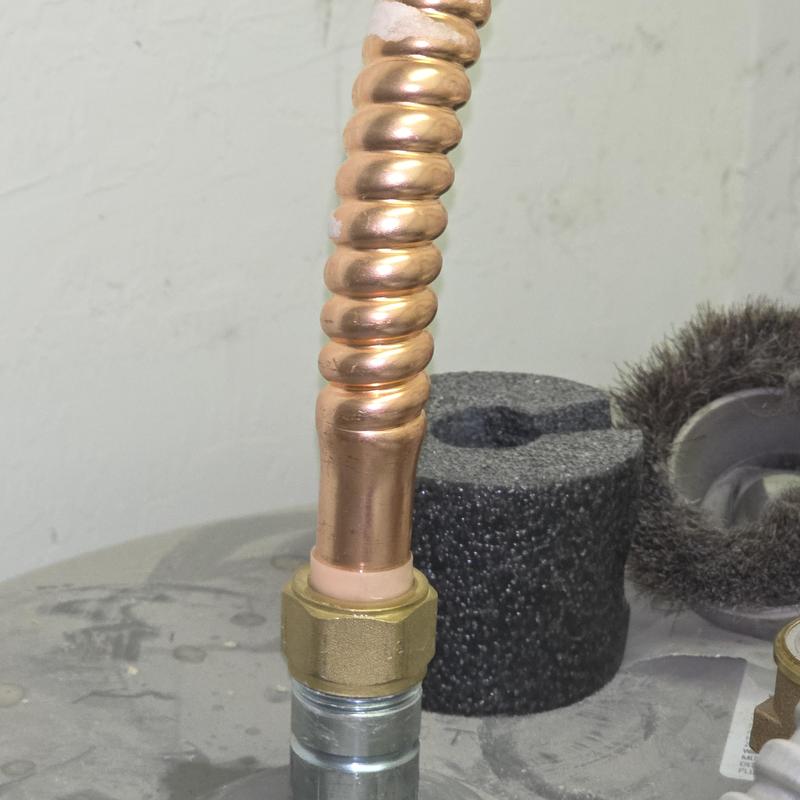 Water heater copper drain valve connection close-up Water heater copper drain valve connection close-up