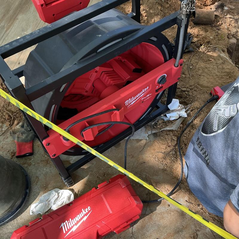 Drain line cleaning machine with flex shaft and measuring tape