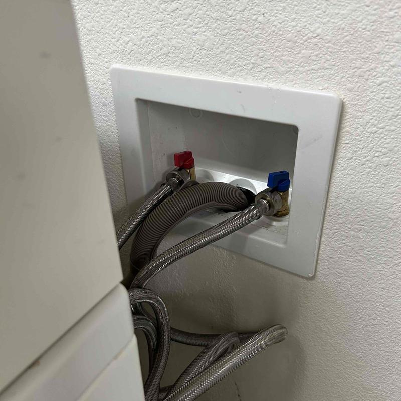 Washing machine water supply valves with hoses connected