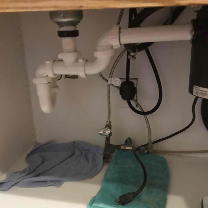 Kitchen sink drainline plumbing with cleaning snake cable