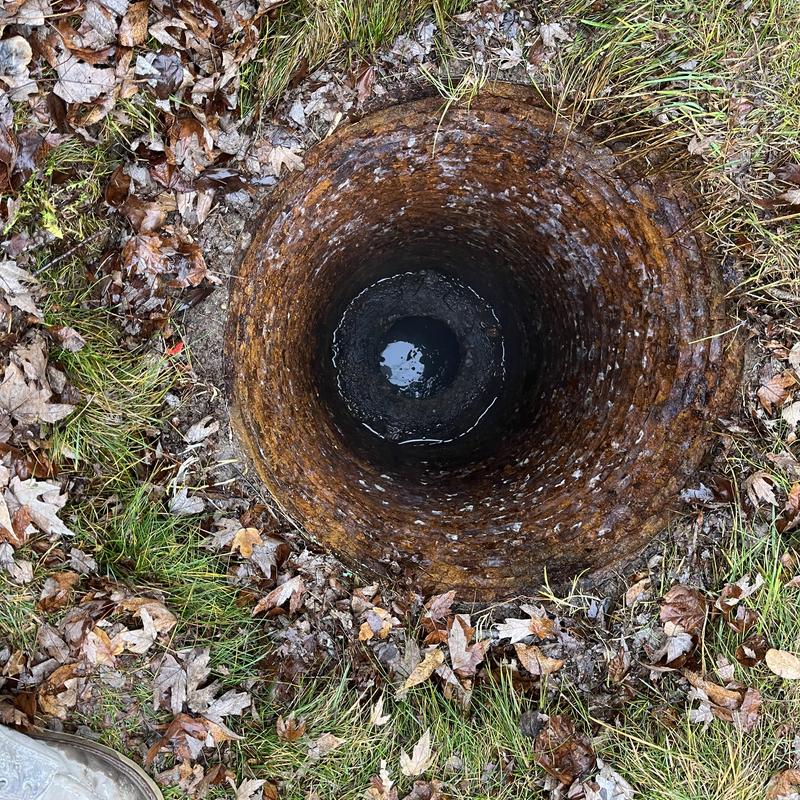 Septic tank riser opening with water inside Septic tank riser opening with water inside