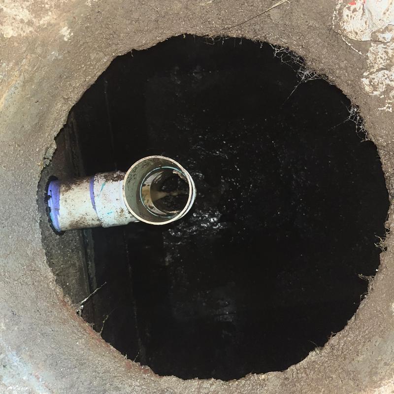 Septic tank interior with discharge pipe visible