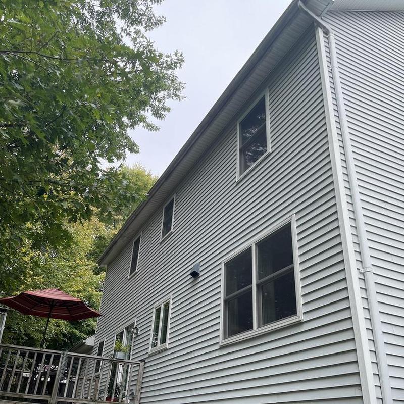 Vinyl siding installation on two-story home exterior Vinyl siding installation on two-story home exterior