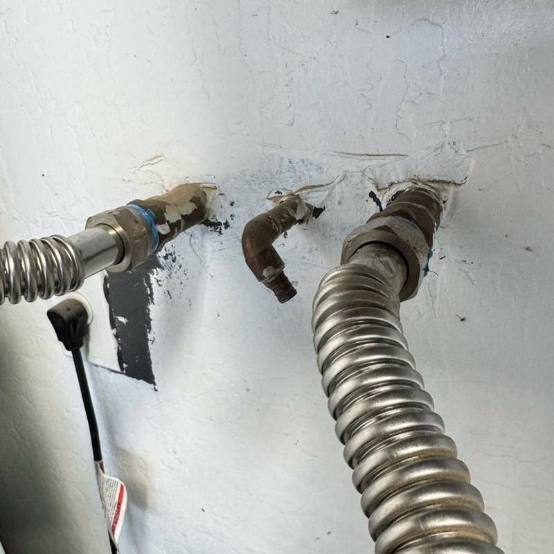 Water softener loop with disconnected hoses on wall