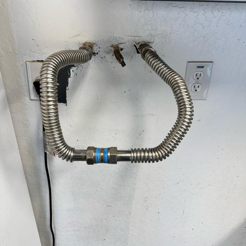 Water softener bypass loop with flexible connectors