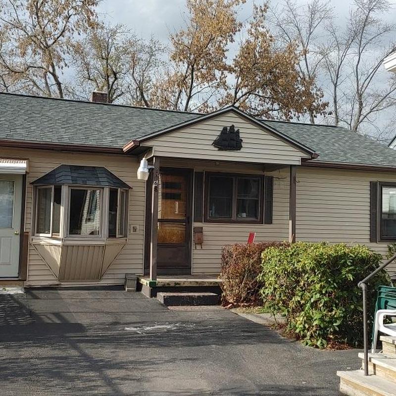 Asphalt shingle roofing on residential home exterior Asphalt shingle roofing on residential home exterior